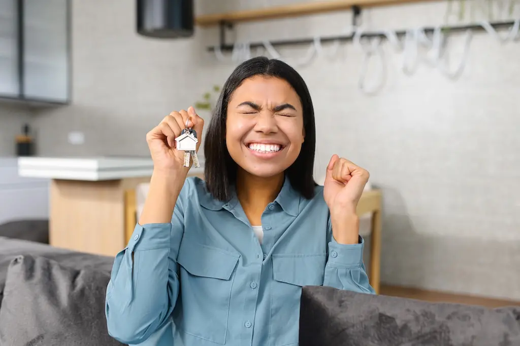 Relocation Concept. Excited Lady Moving In New Home Or Apartment. Overjoyed Woman Homeowner Rejoicing In Front Of The Camera