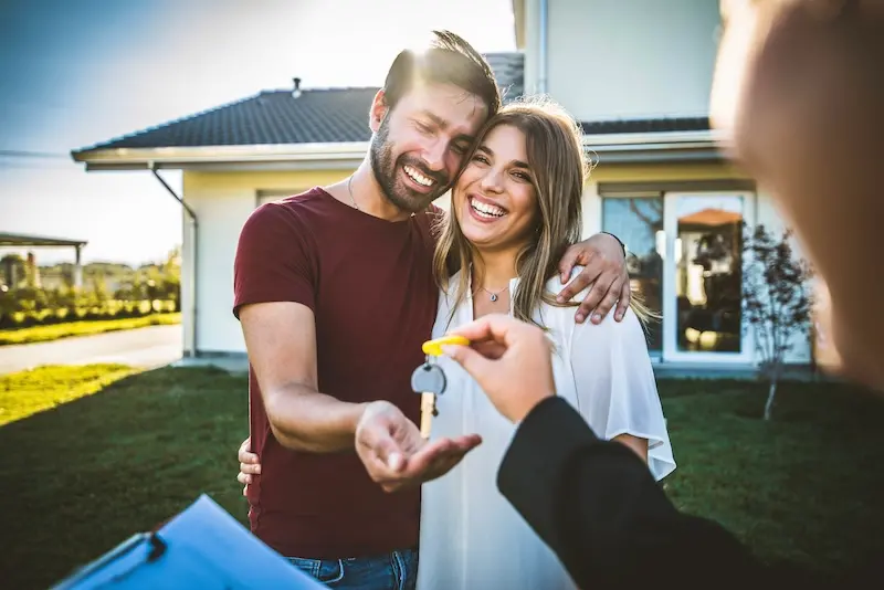 Happy Millennial Couple Receiving Keys From Realtor, Purchasing Real Estate Family Meeting With Real Estate Agent New House And Real Estate Concept